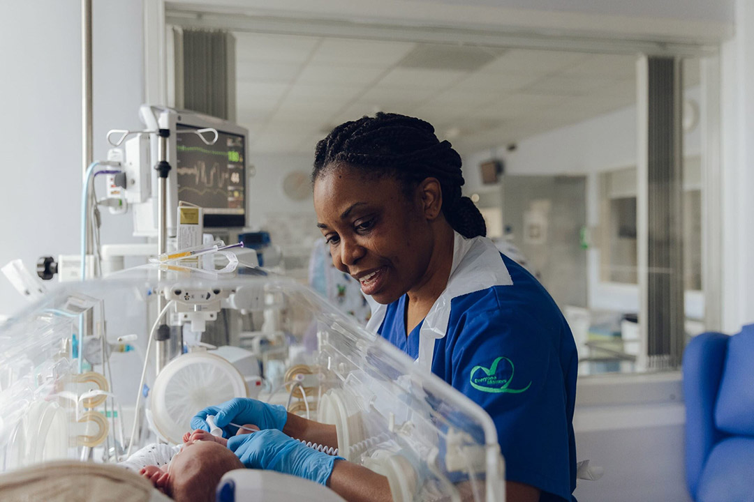 A nurse taking care of a newborn baby