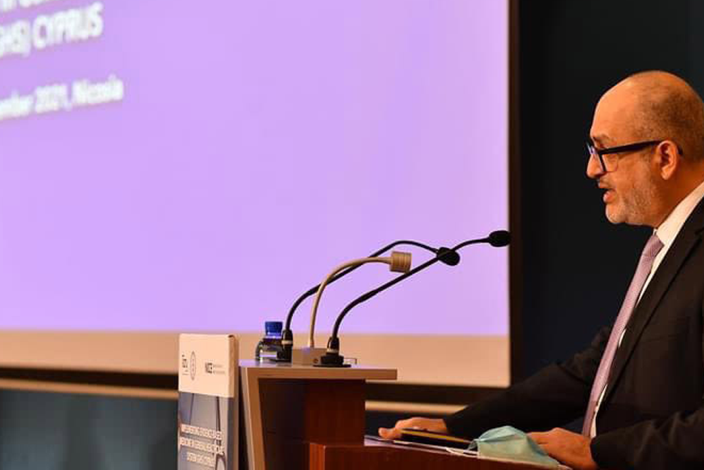 A man stood at a lectern delivering a speech